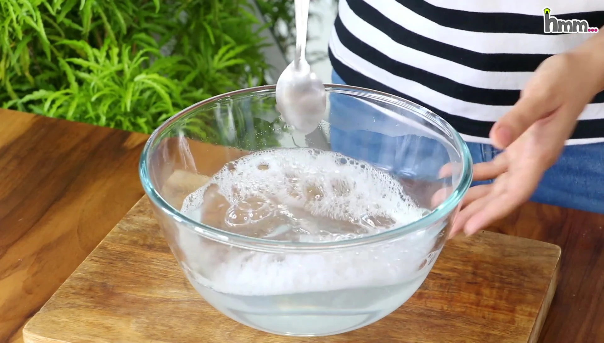Disassembled oil spray bottle parts in soapy water