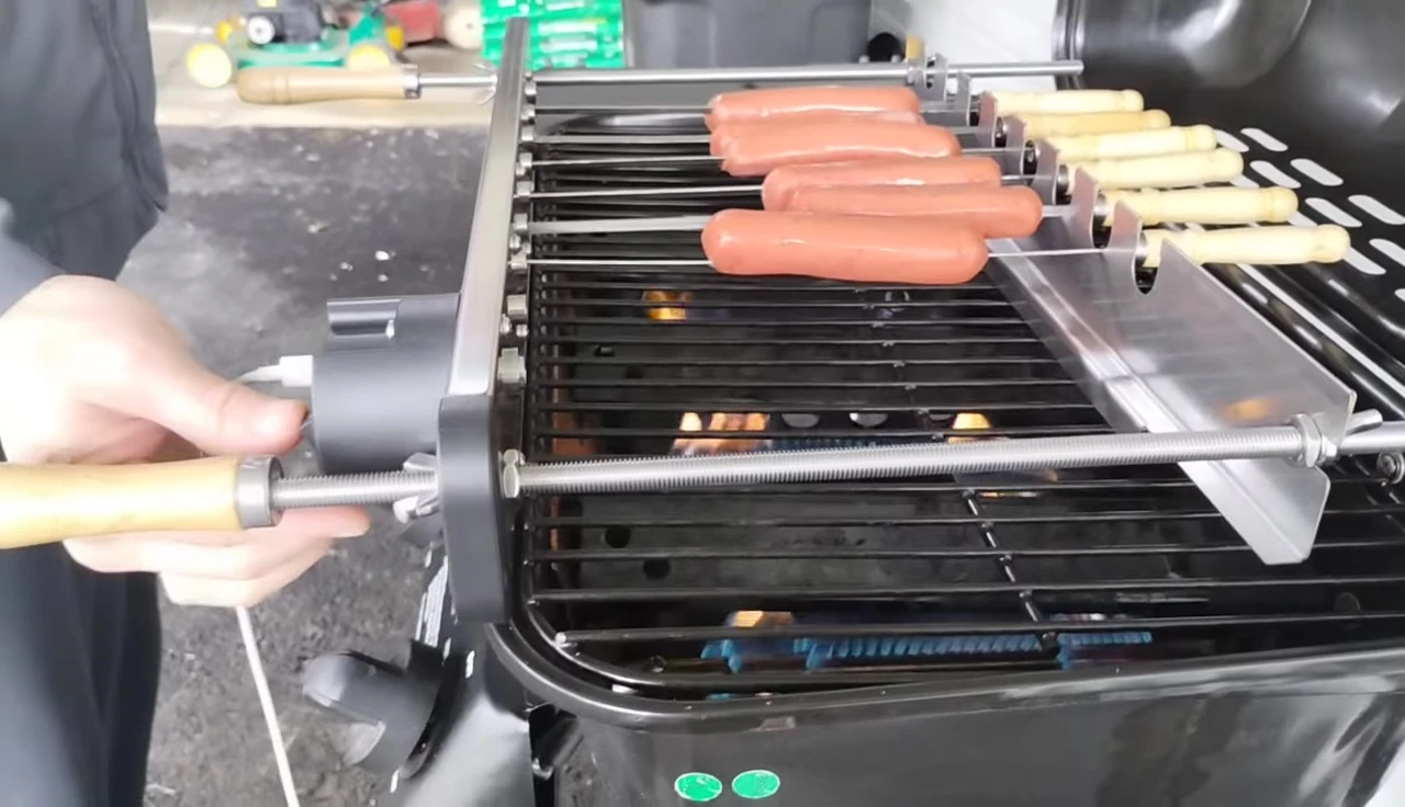 Hot dogs rotating on the skewers.