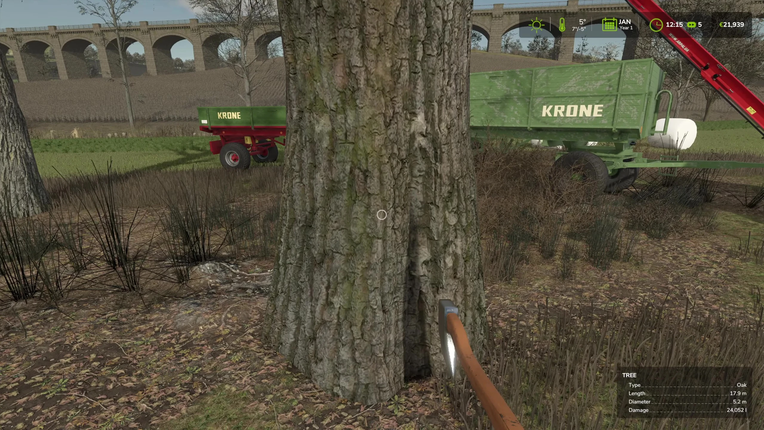 The player operating the wood chipper on a large tree.
