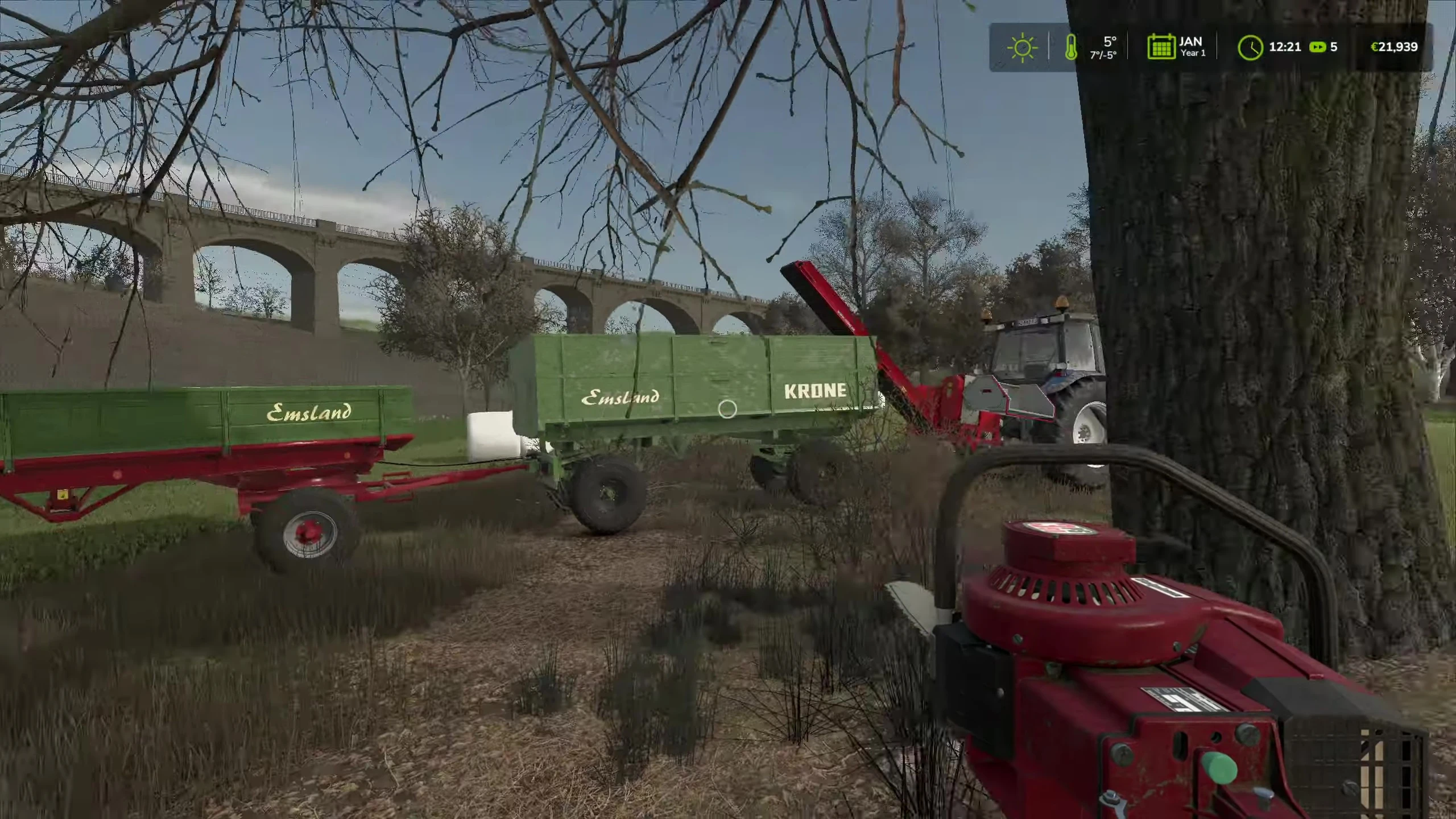 The player filling the trailers with wood chips.