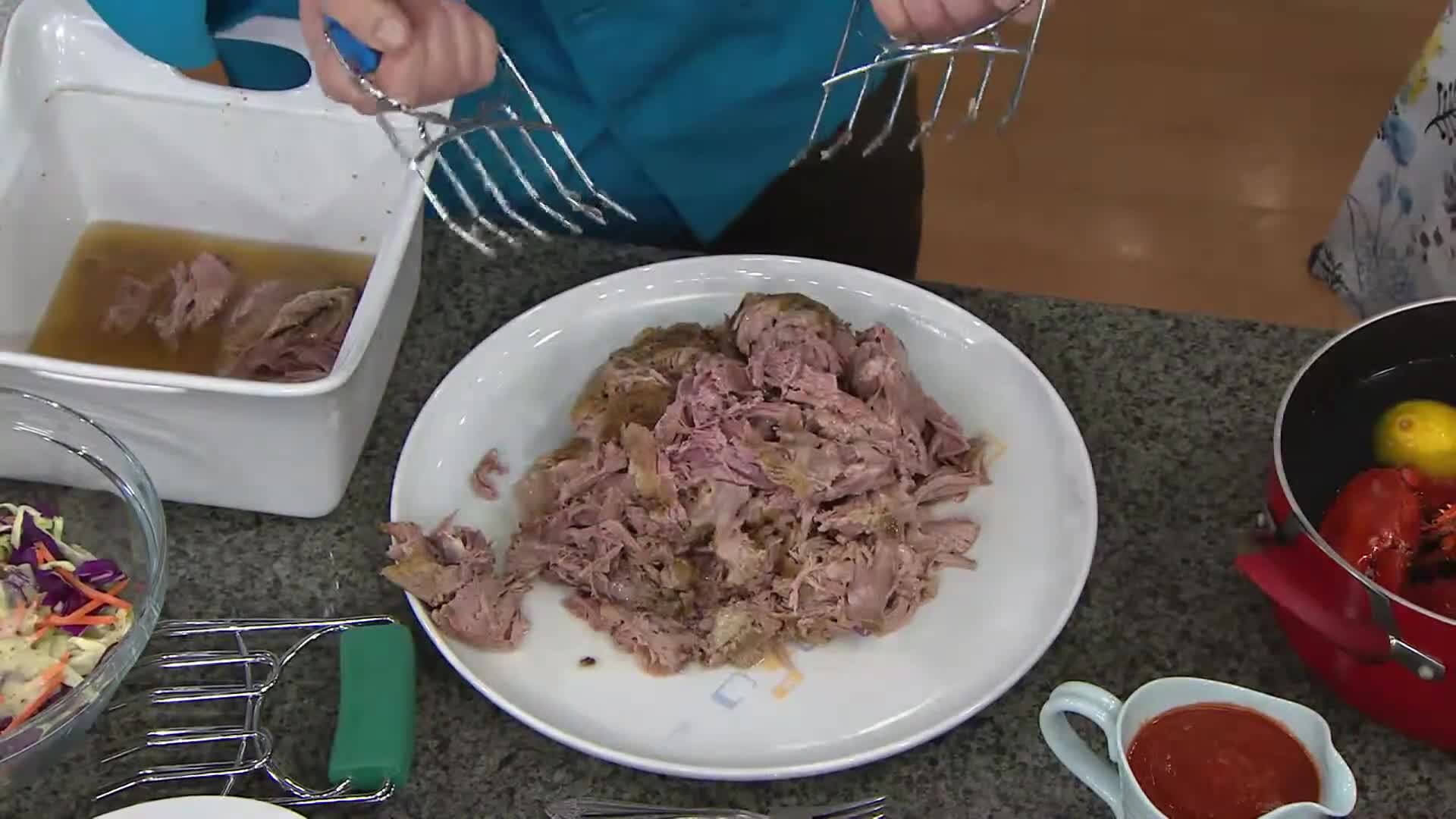 Presenter using the claws to lift and move a brisket