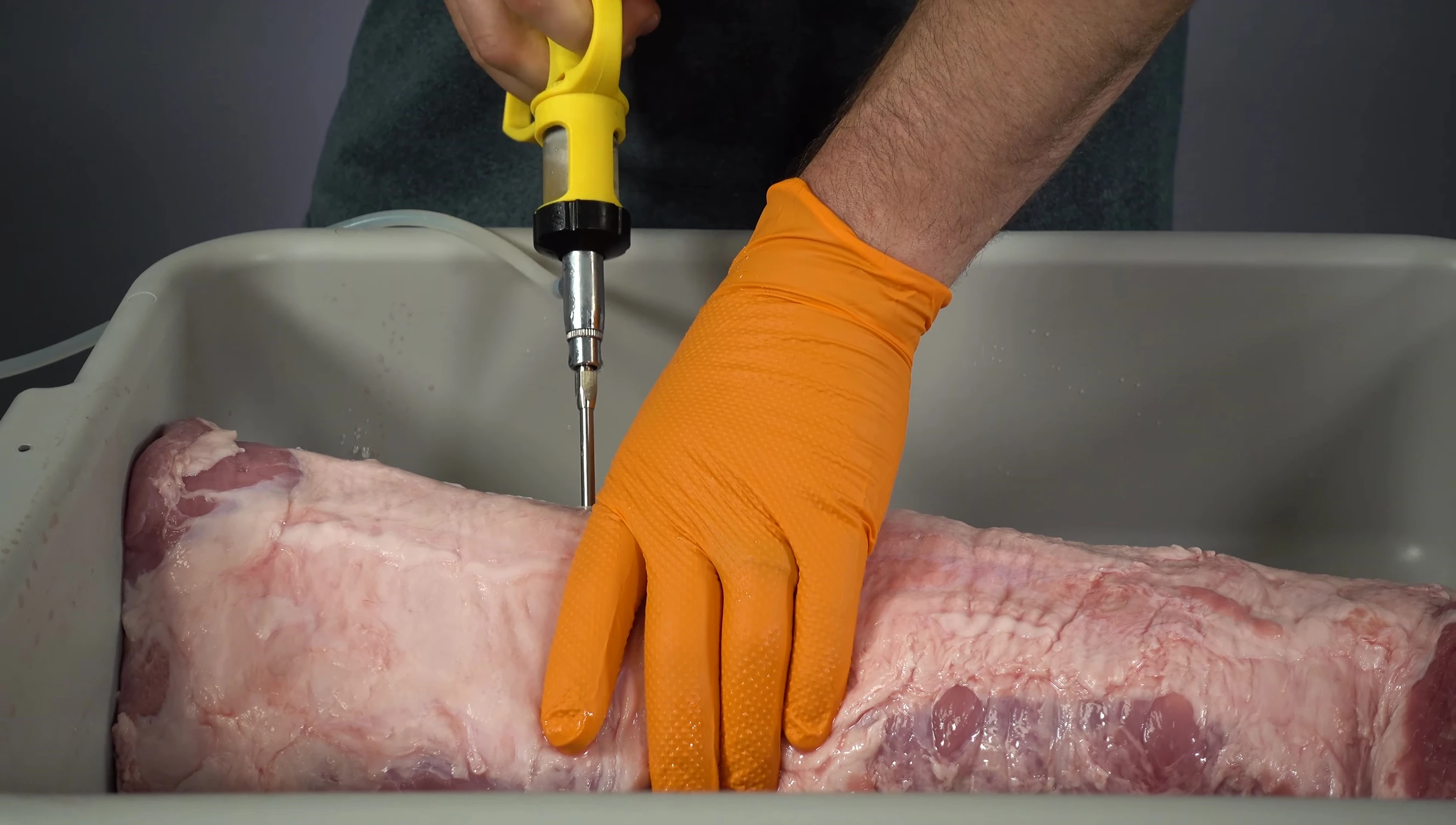 Injecting the pork loin.