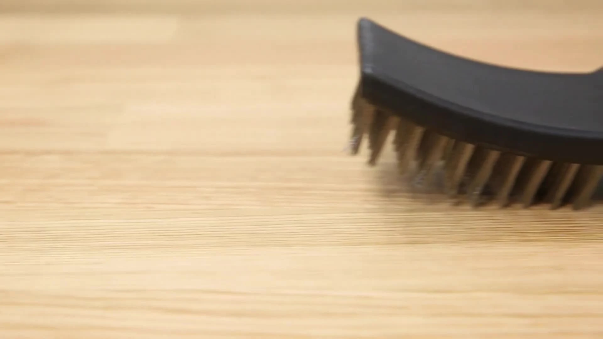 The stainless steel grill brush and other tools displayed.