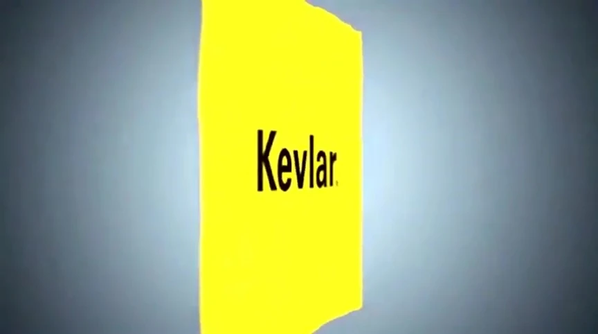 A hand wearing a Kevlar glove near a flame.