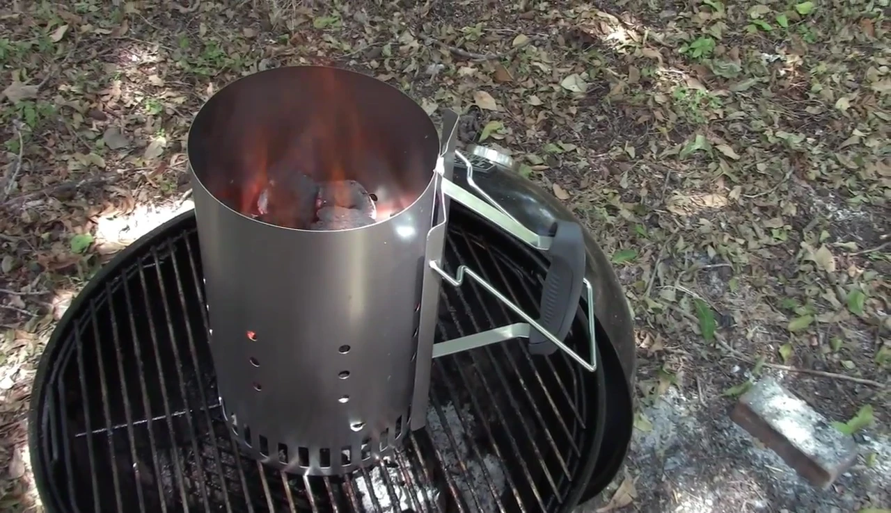 The reviewer holding the Weber chimney starter, showing its size