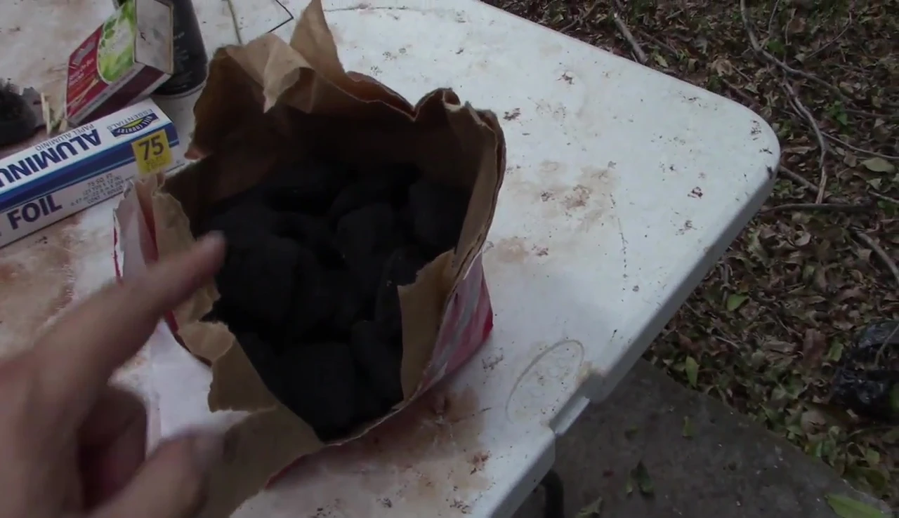 Filling the Weber RapidFire Chimney Starter with charcoal briquettes