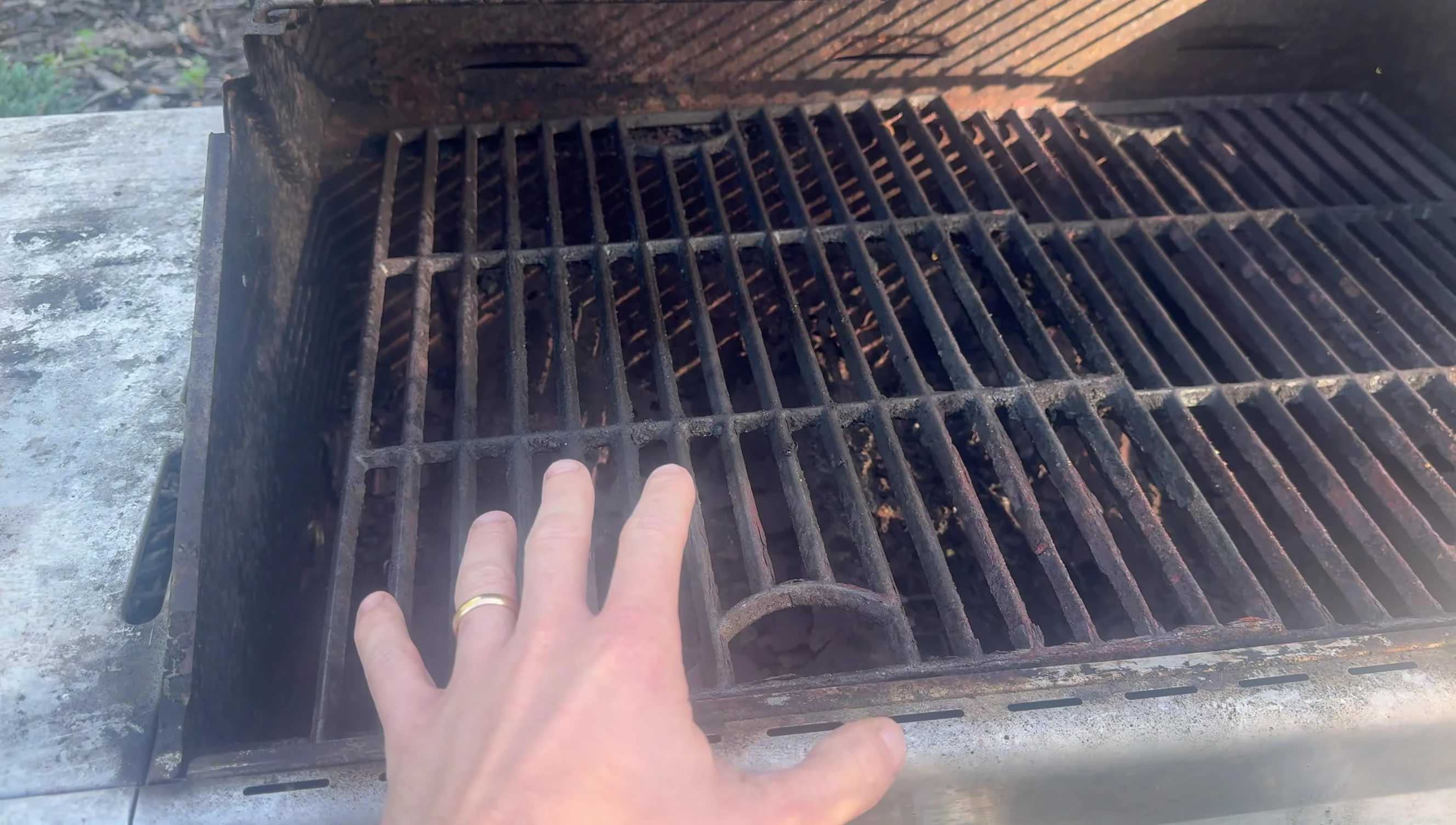 A shot that shows the reviewer considering if they should buy another inexpensive grill or a more expensive, longer-lasting one.