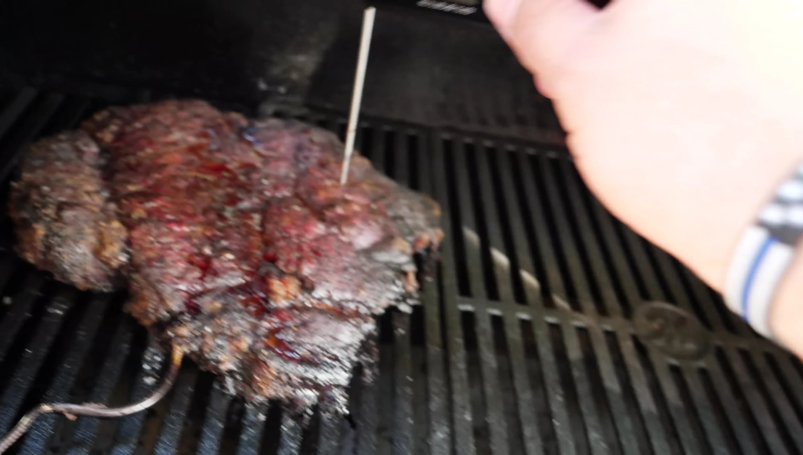 Performing the poke test on the Masterbuilt chuck roast.
