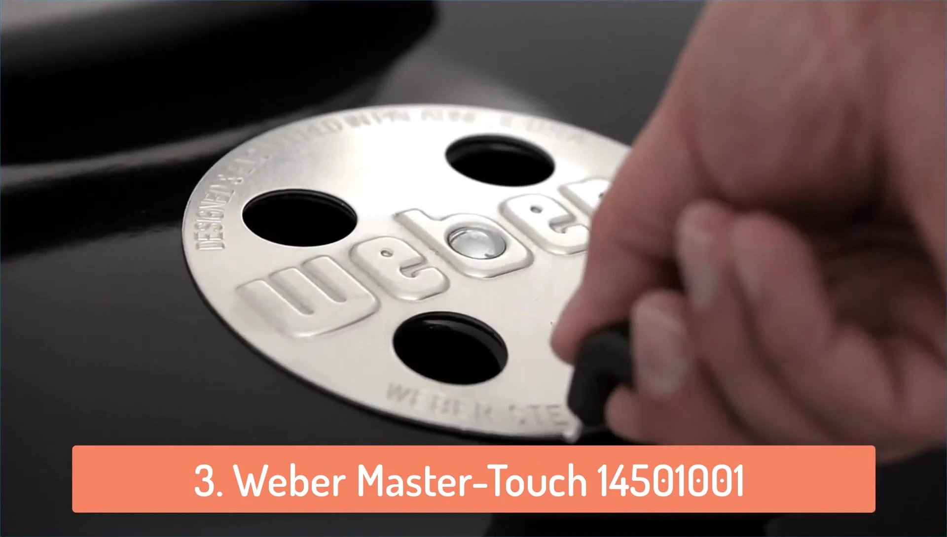 Close-up of the Weber Master Touch's One-Touch cleaning system.
