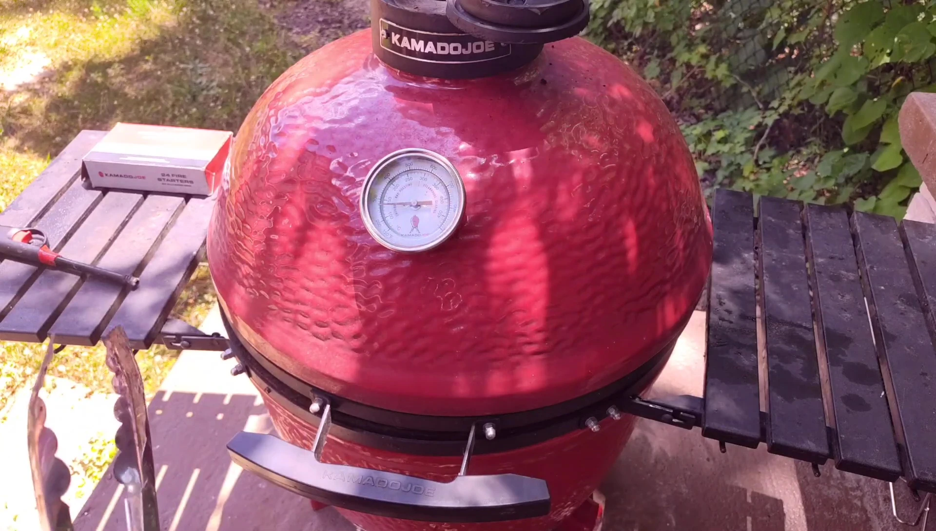 Observing the color of the smoke to determine the readiness of the fire.