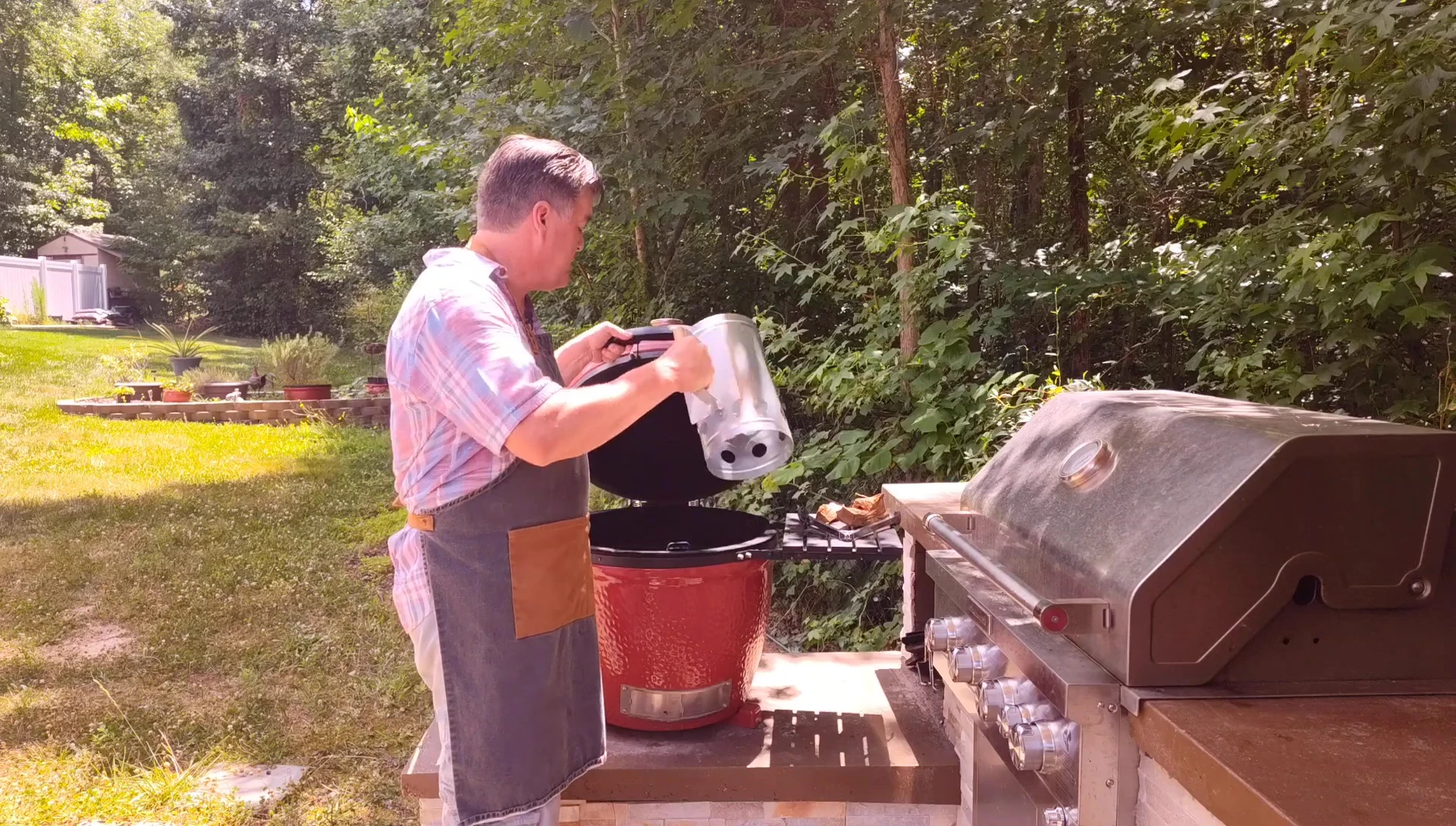 Pouring the hot coals from the chimney starter into the kamado grill.
