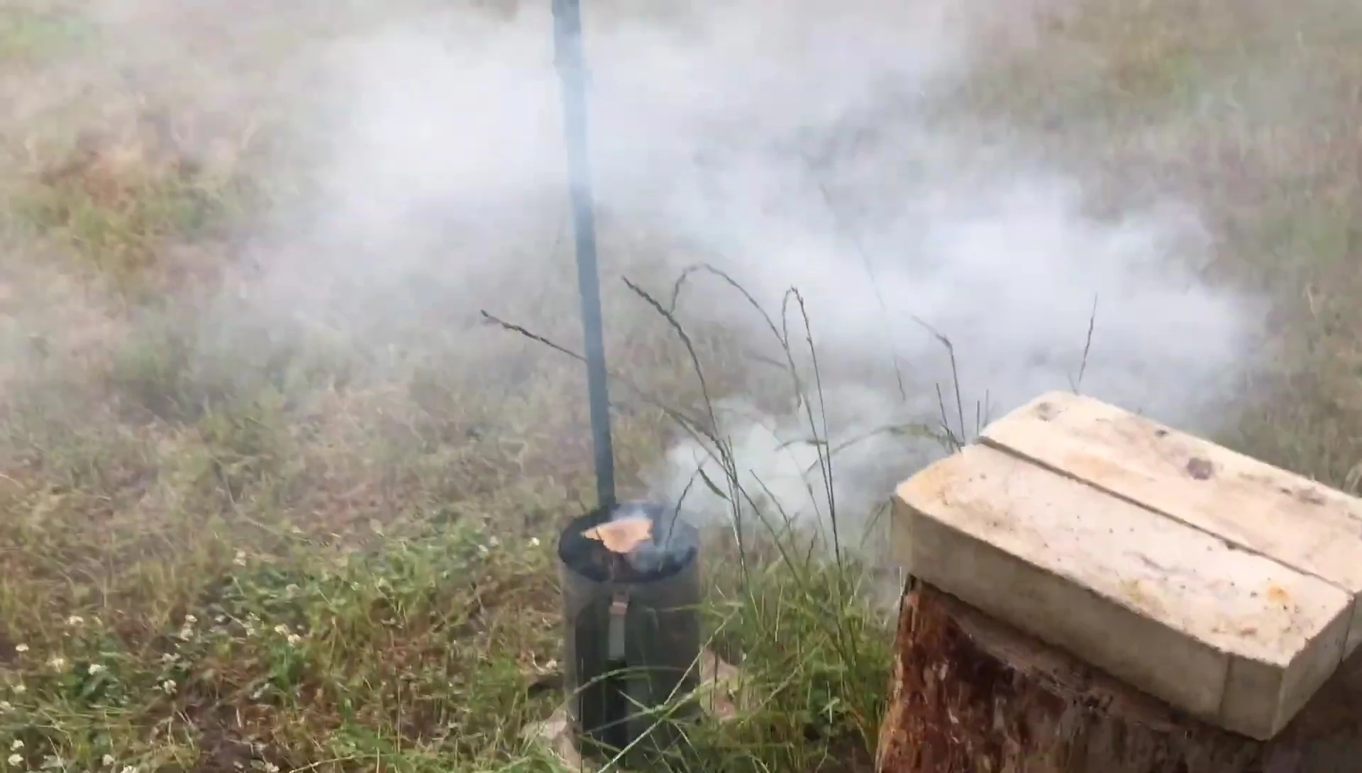 Adding pre-burned wood to the firebox.