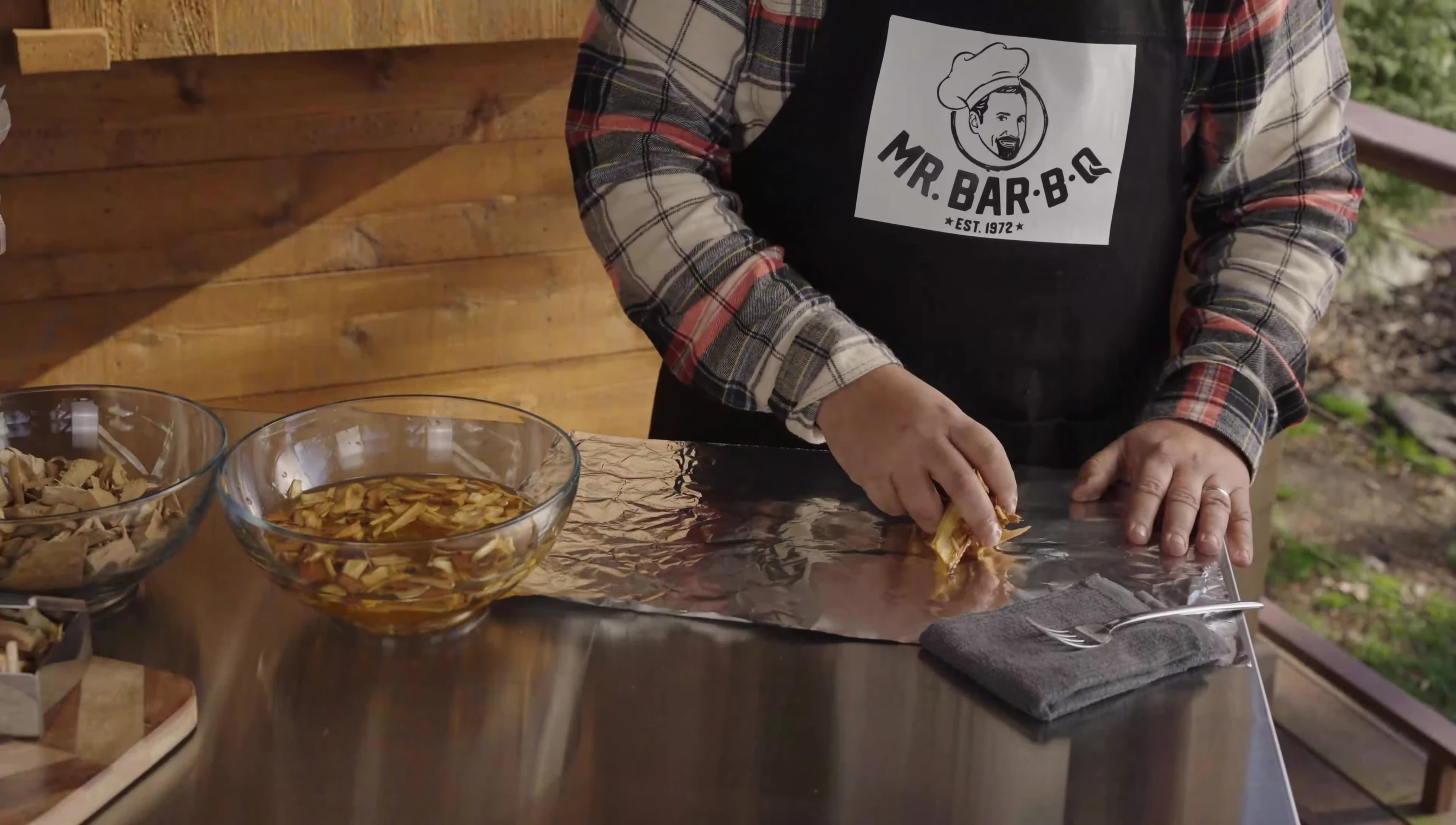 Demonstration of creating a foil packet with wet and dry wood chips.