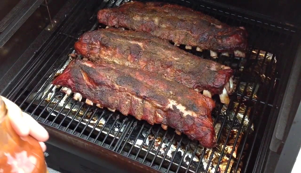 Applying the cherry barbecue sauce to the ribs.