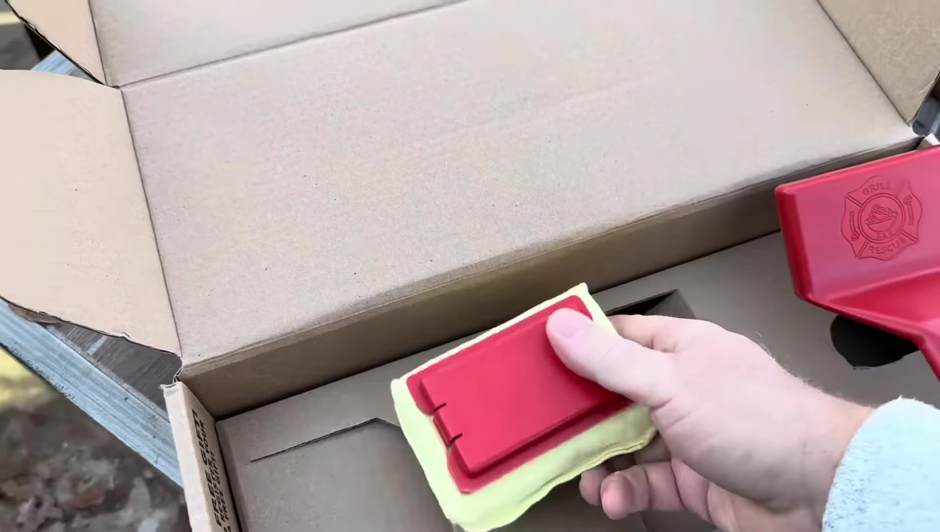 The two parts of the Grill Rescue brush being clipped together.
