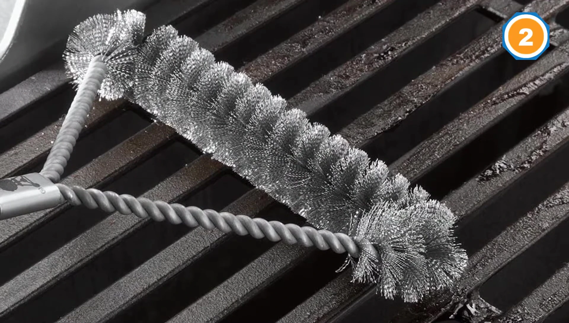 The Weber brush cleaning a grill surface.