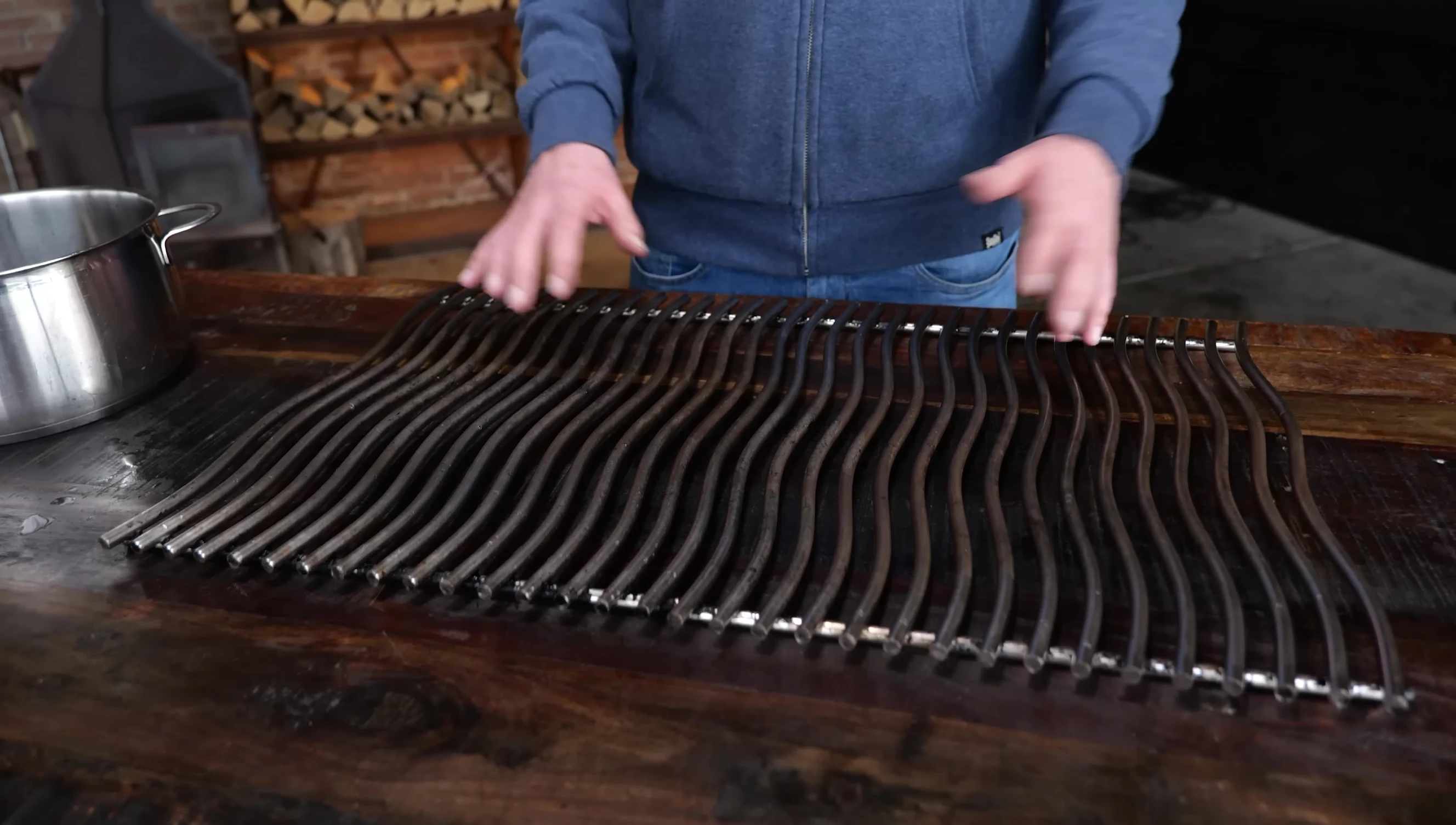 Scrubbing the grill grates with a sanding pad
