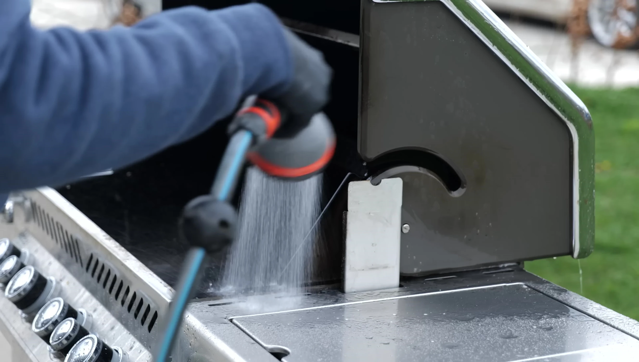 Cleaning the grill exterior with an abrasive pad and soapy water