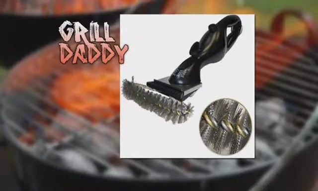 Close-up of the Grill Daddy brush being used on a grill grate.