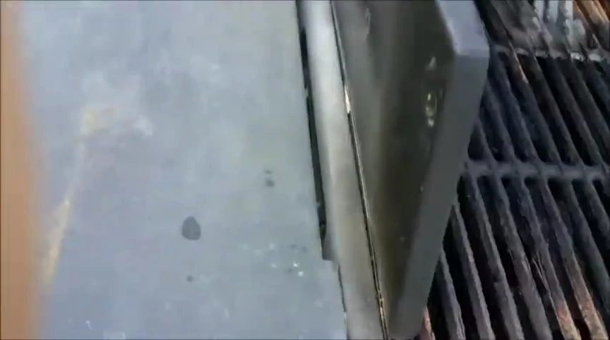 Demonstrating the angle and downward pressure while scrubbing.