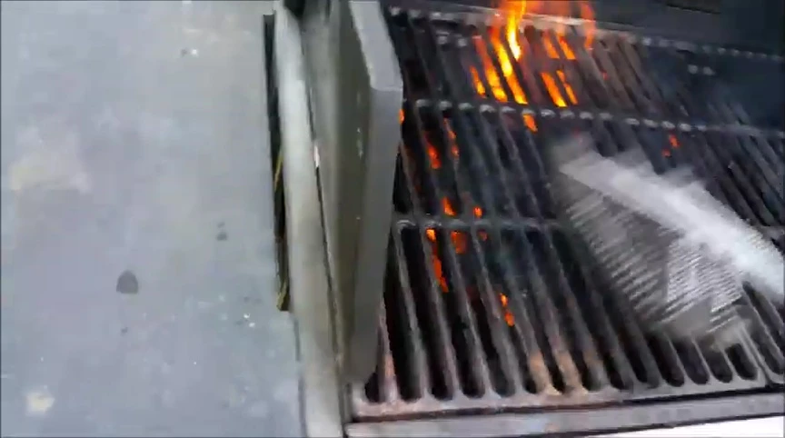The brush in action on the hot grill.