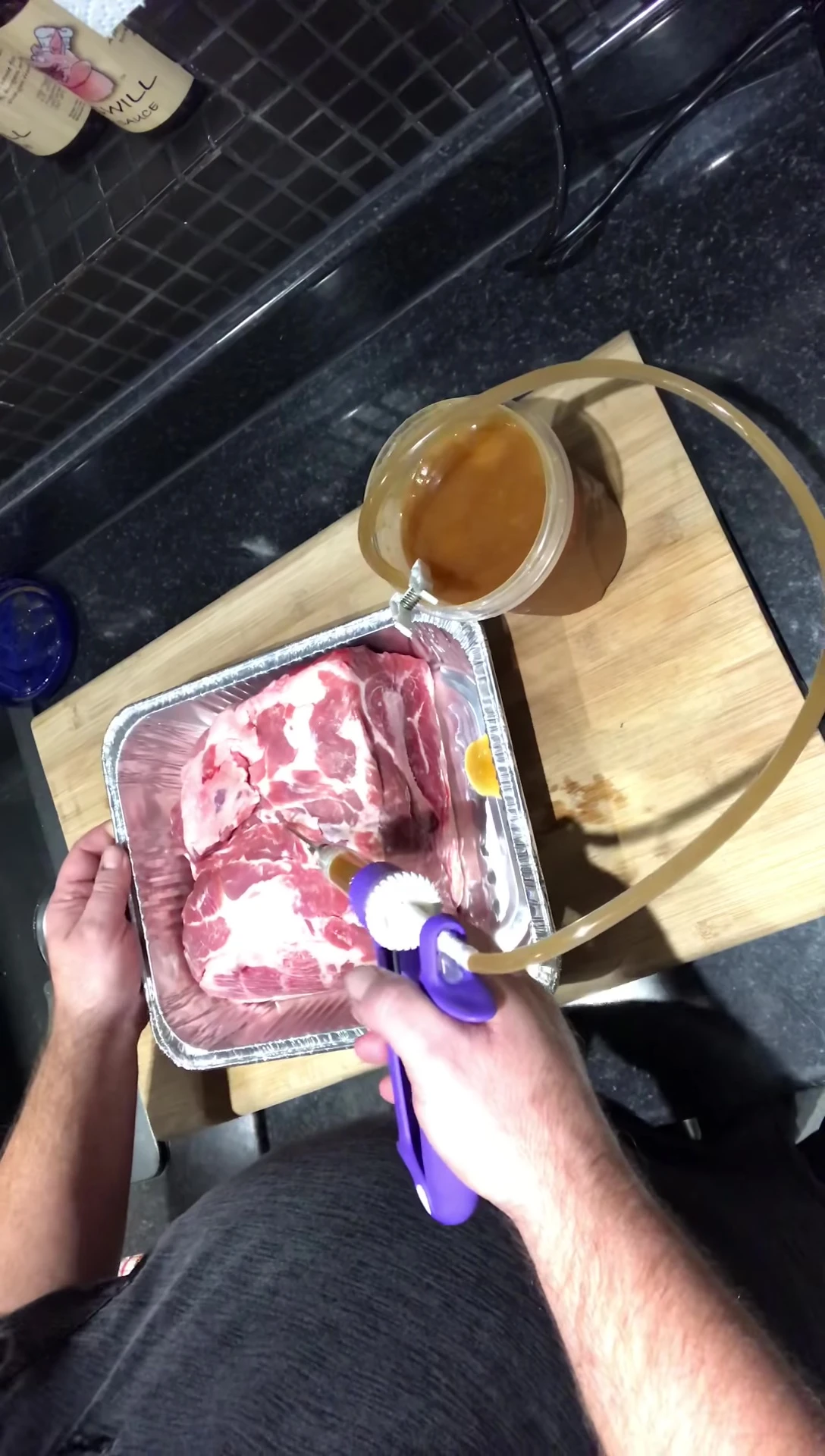 Inserting the needle into the meat.