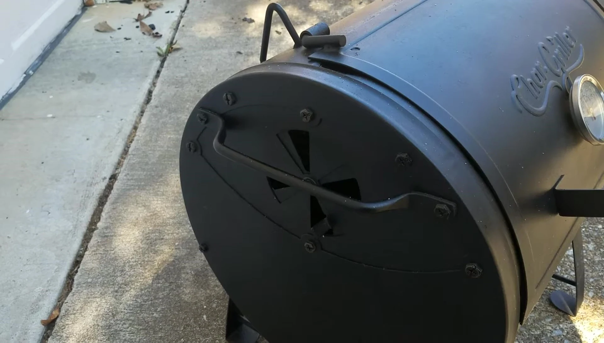 The portable grill being moved.