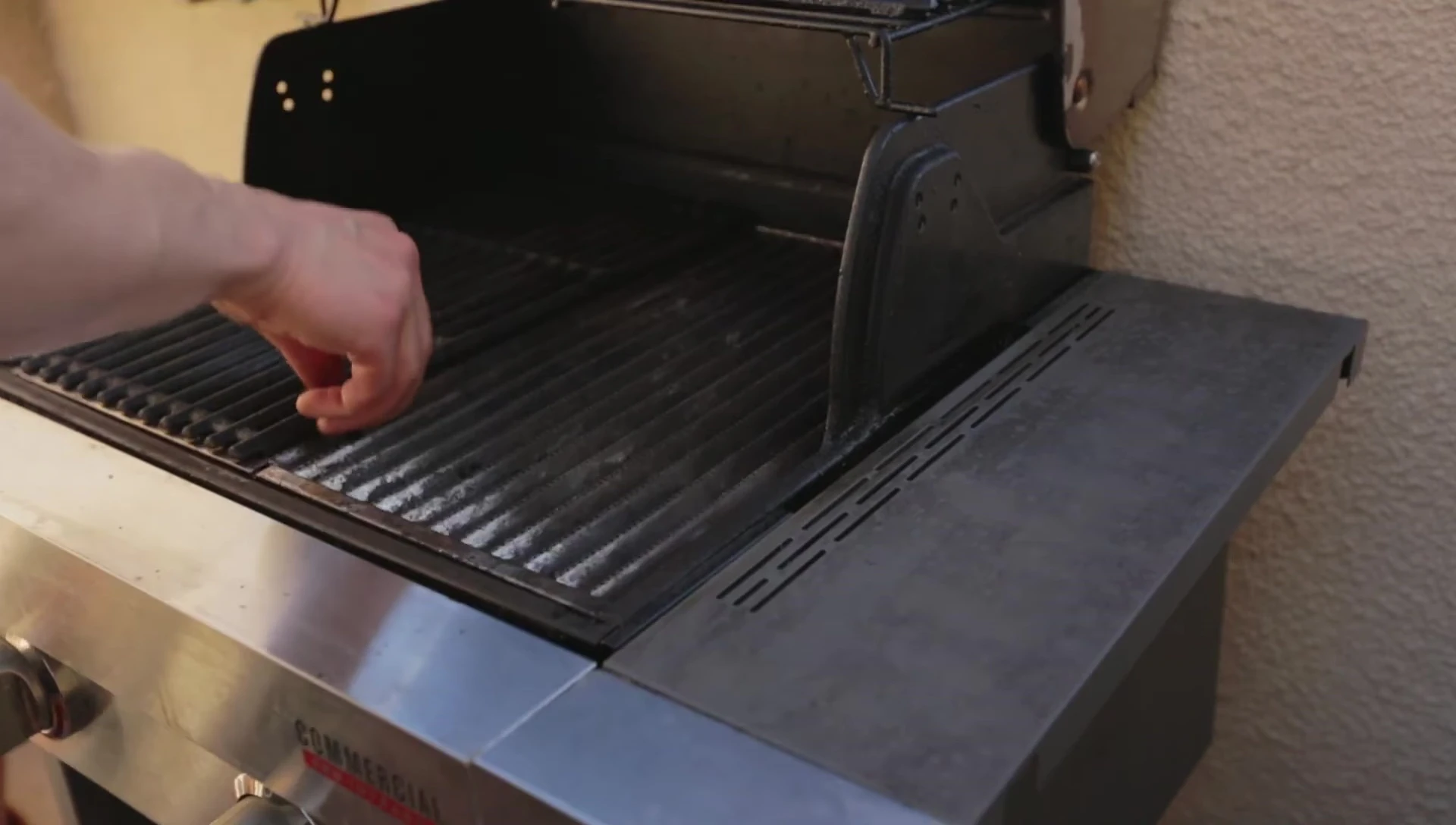 Close-up of the grill grates and scraper tool.