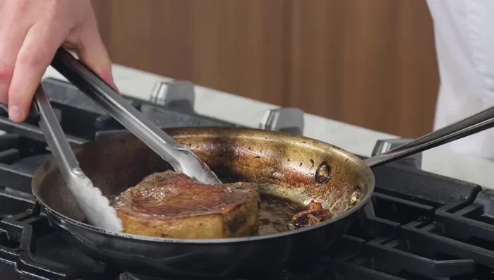 Remove the pork chop from the pan and let it rest on a rack for 5-7 minutes to redistribute juices.