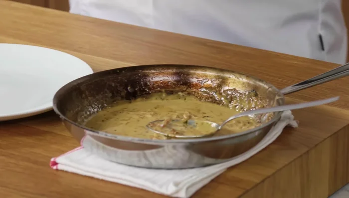 Serve the rested pork chop generously drizzled with the pan sauce.