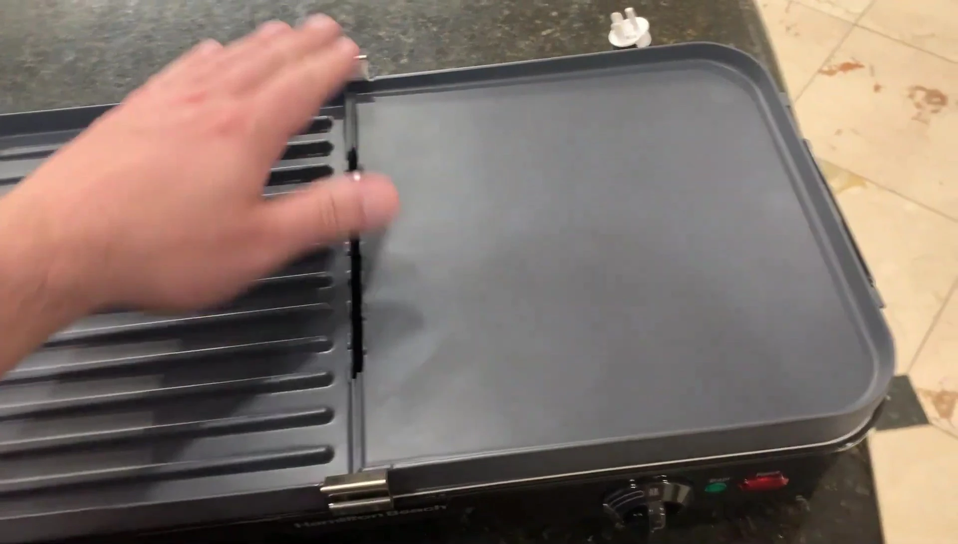 Demonstrating the removal of the cooking plates
