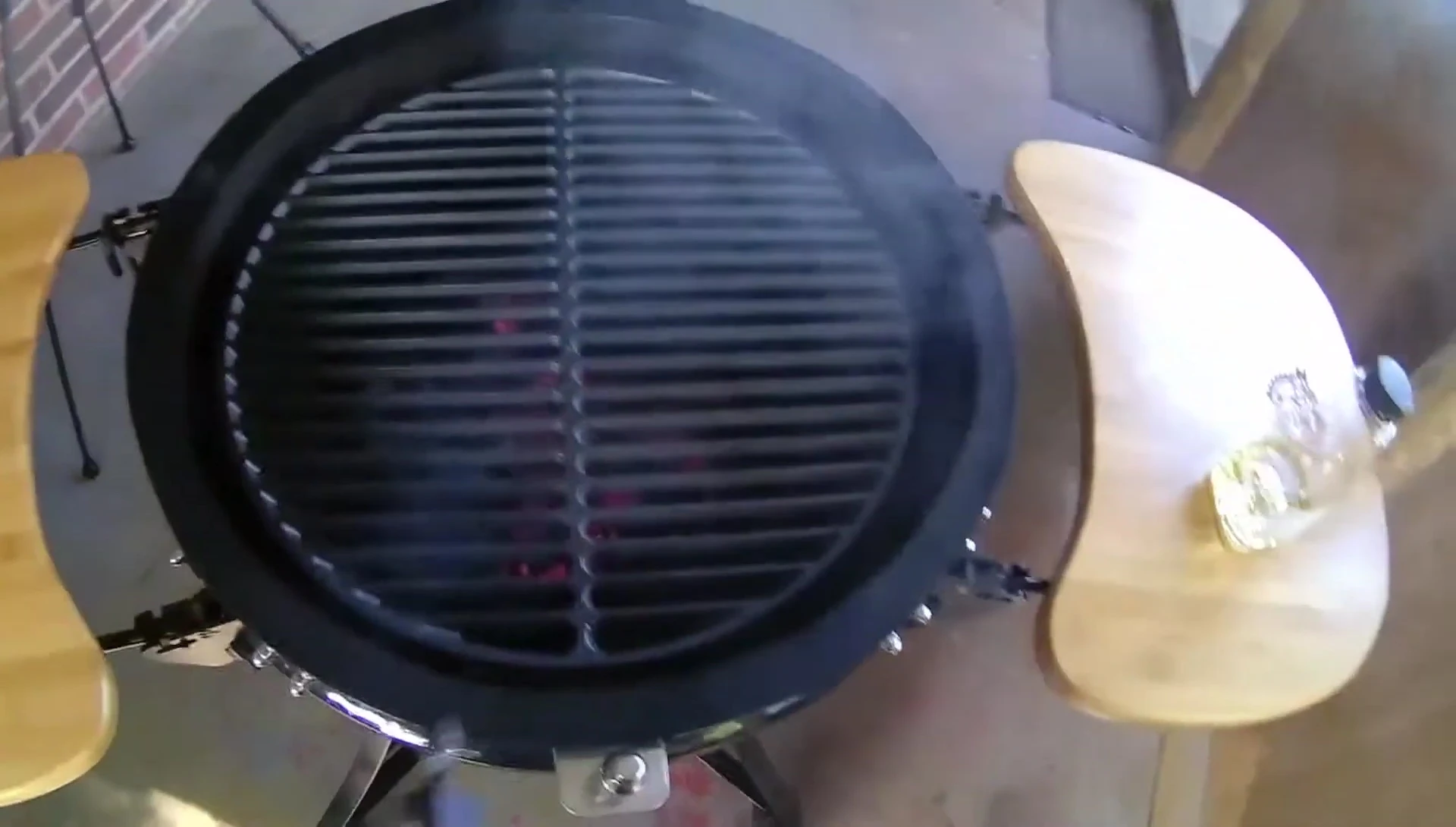 The grate being placed into the grill, showing the fit.