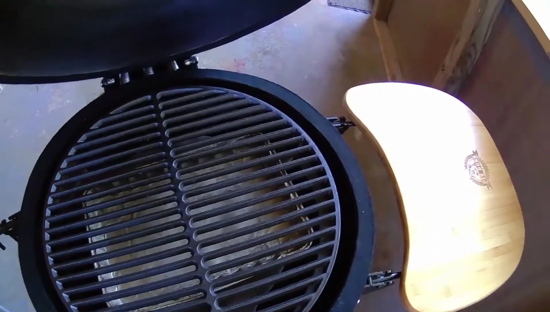 Demonstration of the proper lifting technique for the grate.