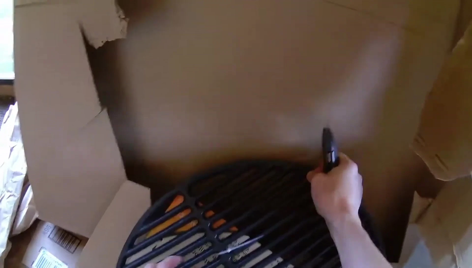 The speaker preparing to use the grate for cooking.