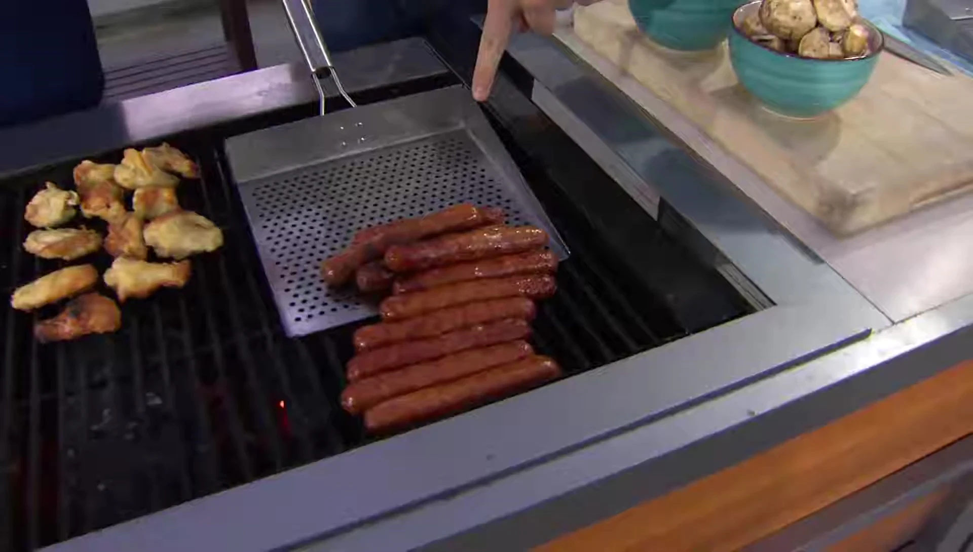 Multiple hot dogs grilling on the plate.