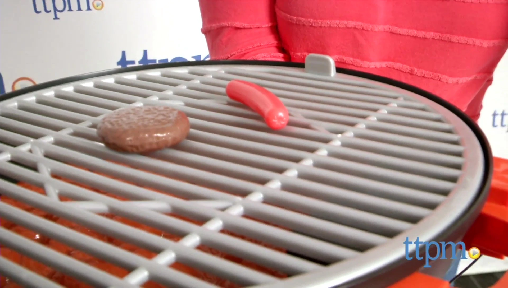 The grill accessories including apron, burger, hotdog, and condiments.