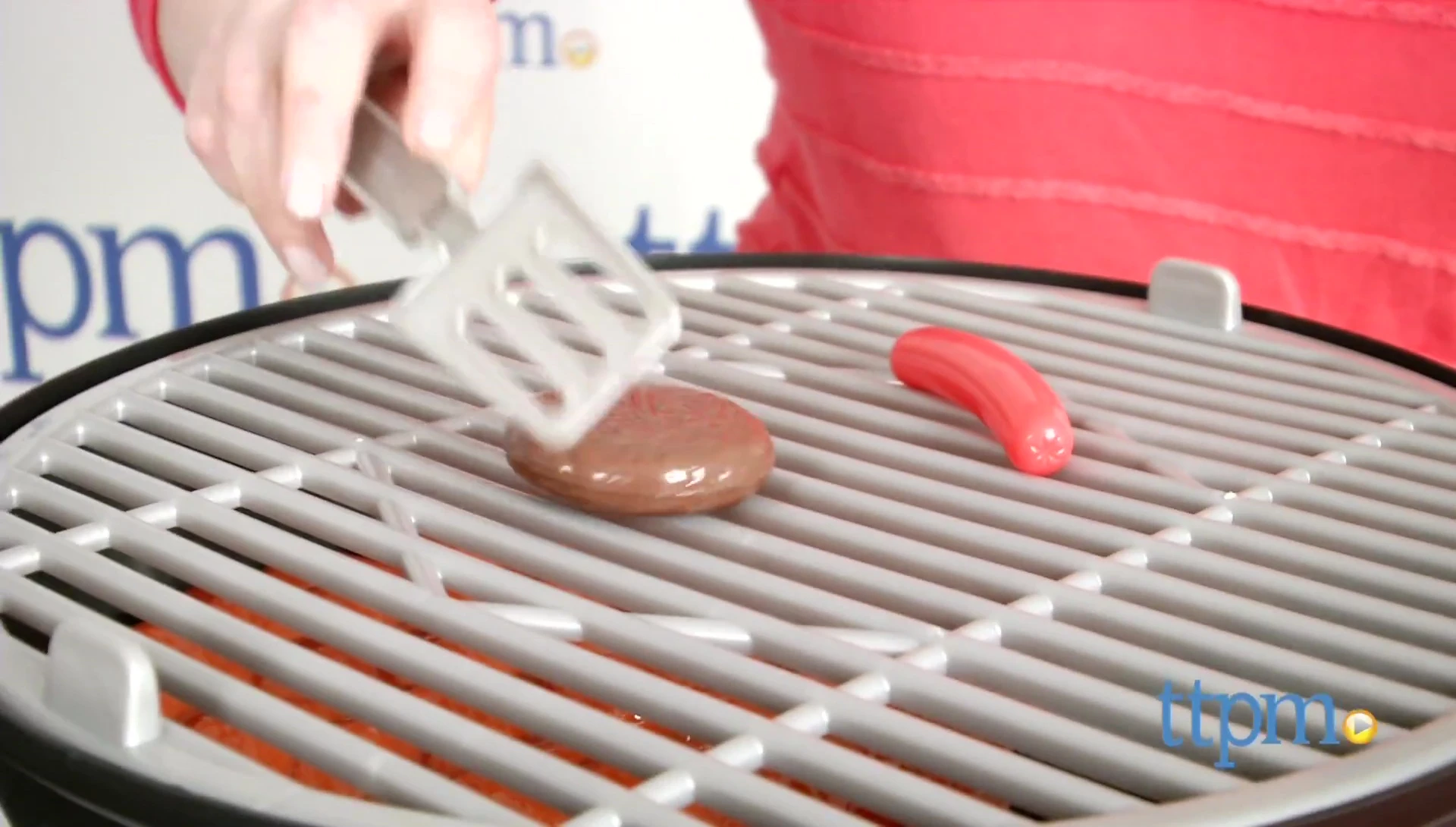 Close-up of child using the spatula and tongs