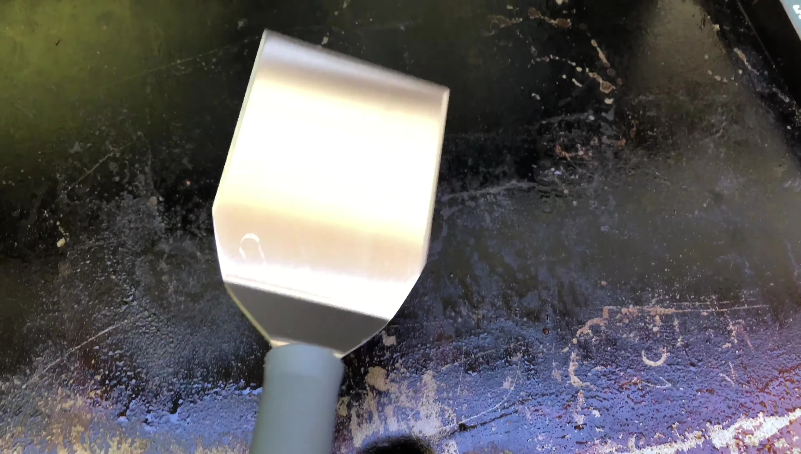 The square turner is shown before flipping the eggs