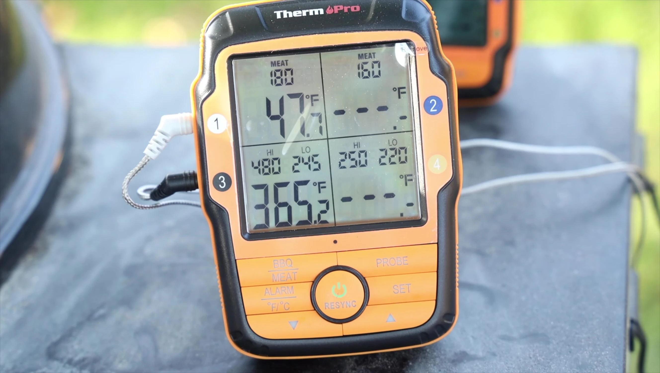 The reviewer testing the range of the wireless thermometer