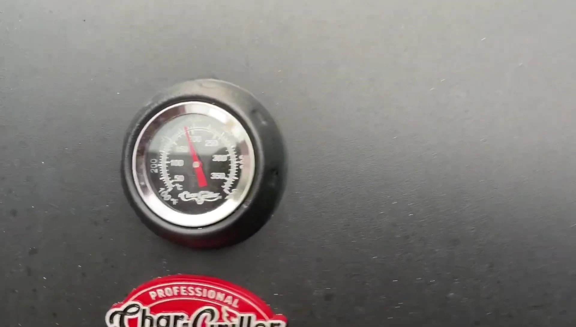 The grill thermometer displaying the temperature reaching 375°F.