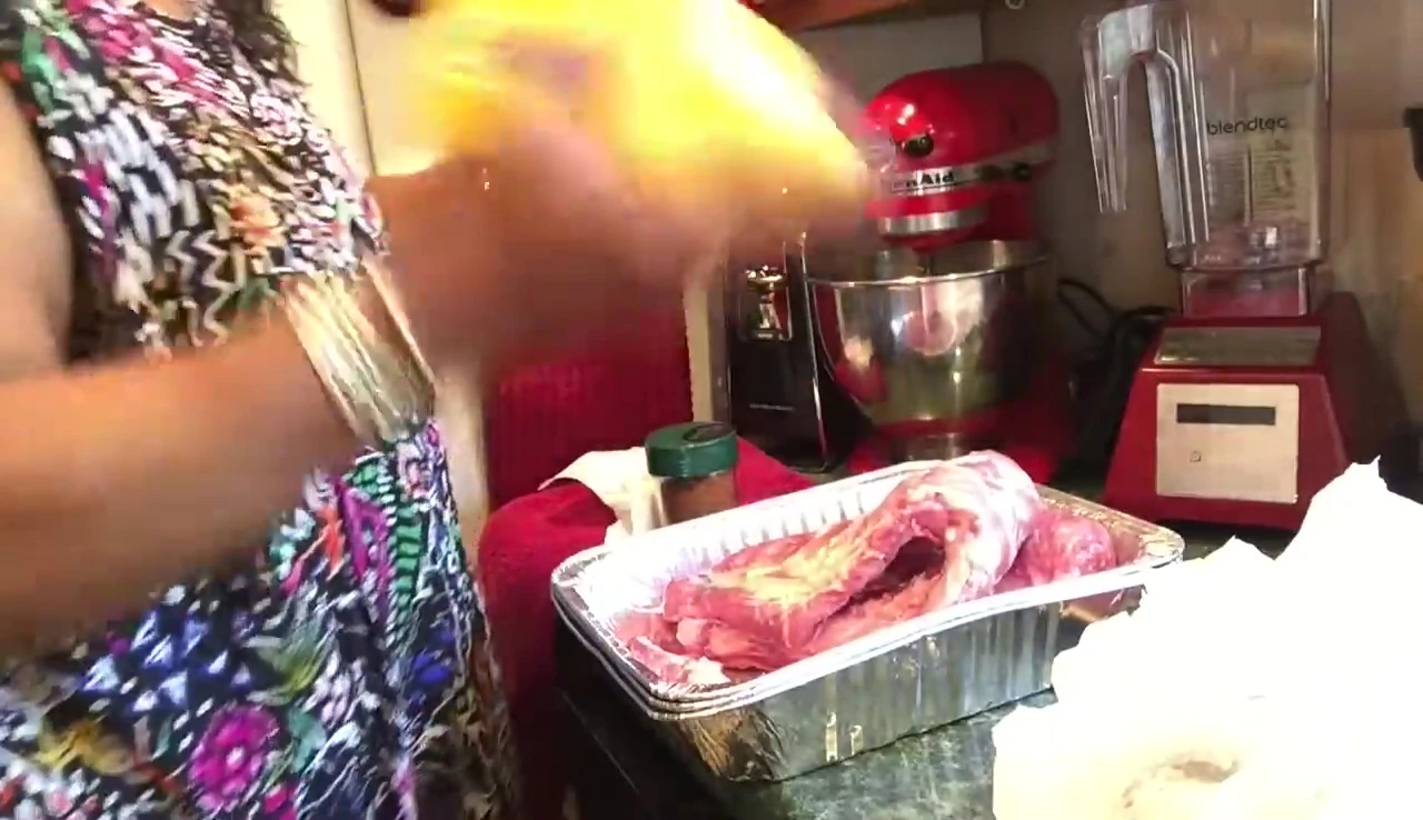 Applying yellow mustard to the ribs