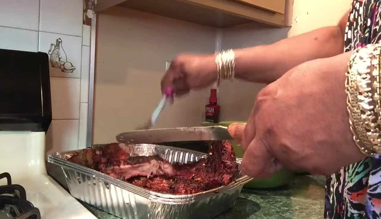 Applying homemade barbecue sauce to the ribs