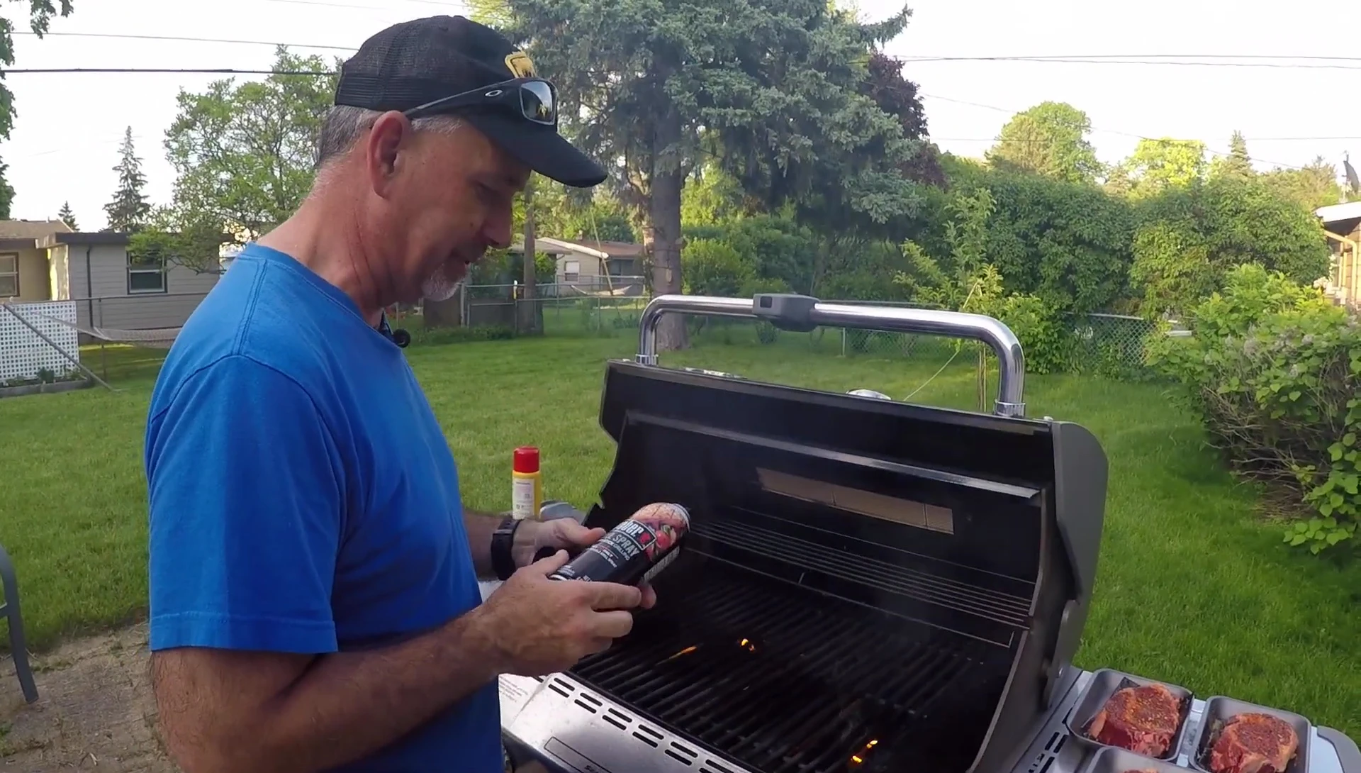 Weber Grill Spray being used on the grill, no flames.