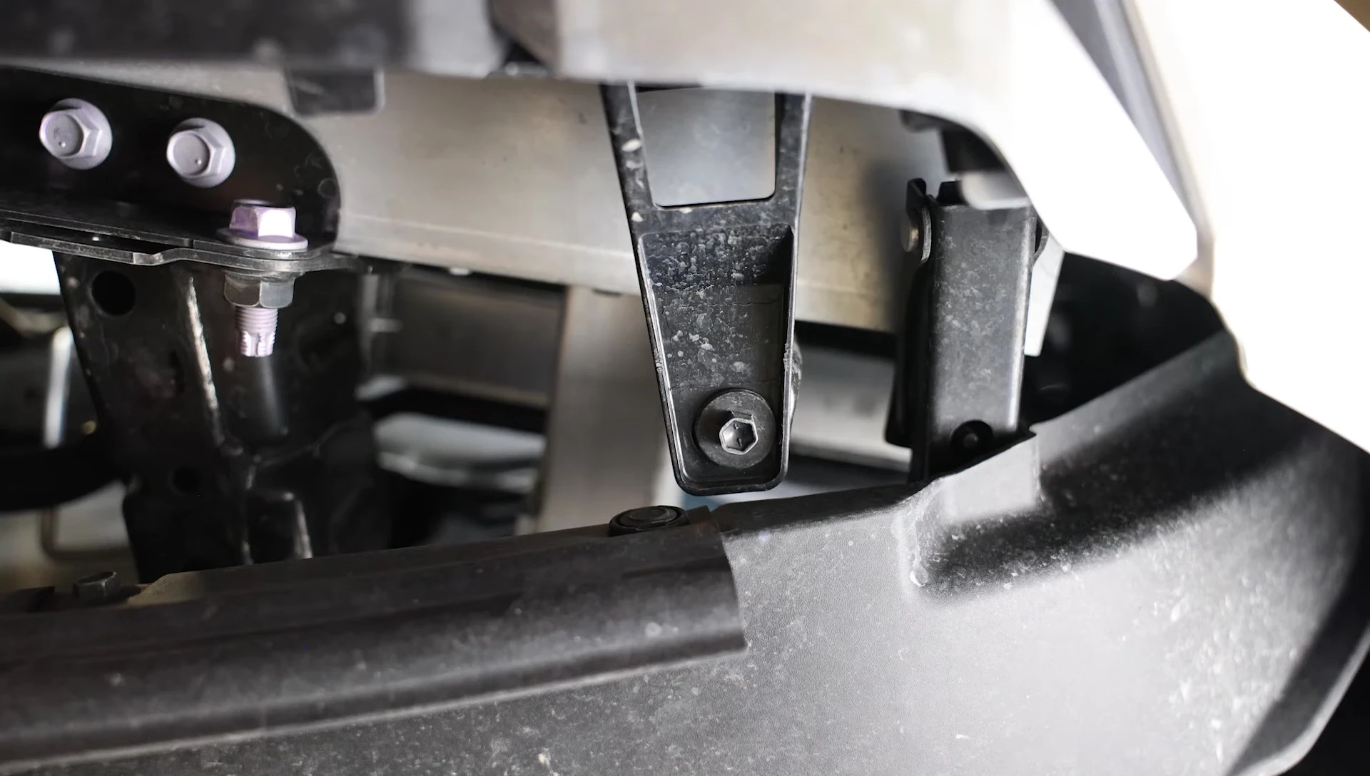 Removing 10mm bolts from the front brackets