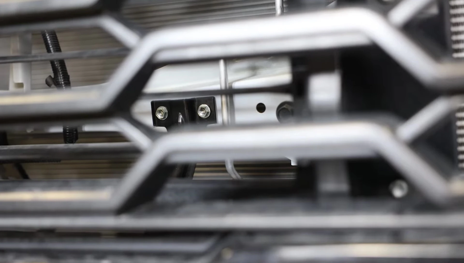 Removing 10mm bolts behind the grille