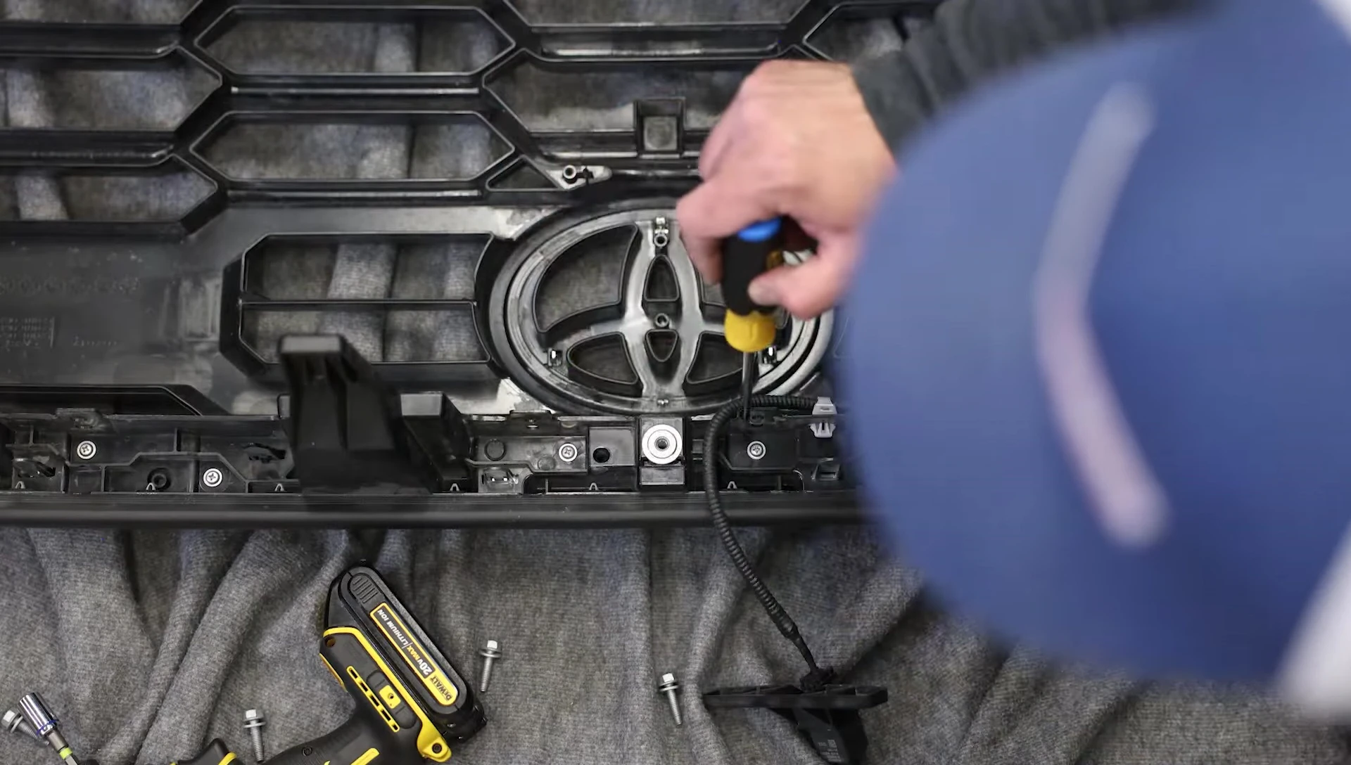 Removing screws from grille surround