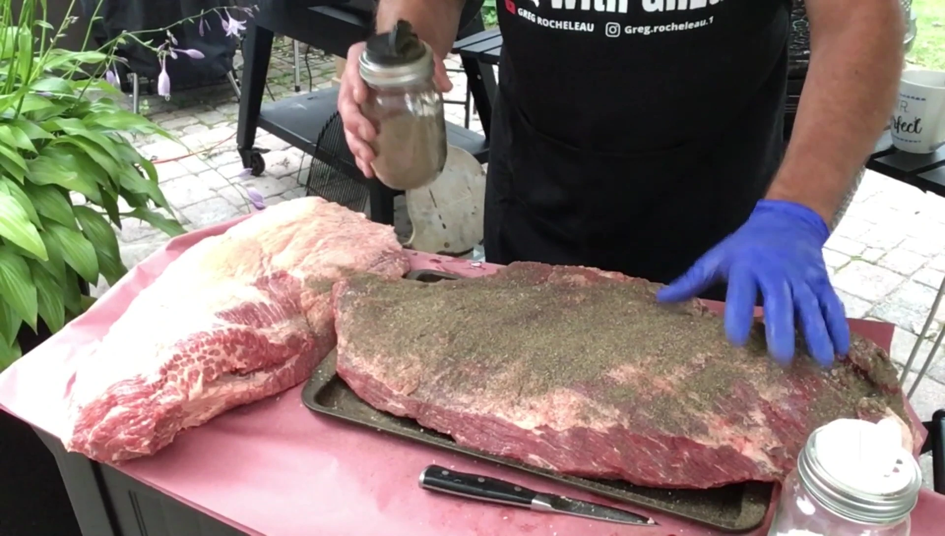 Seasoning the brisket with salt and pepper.