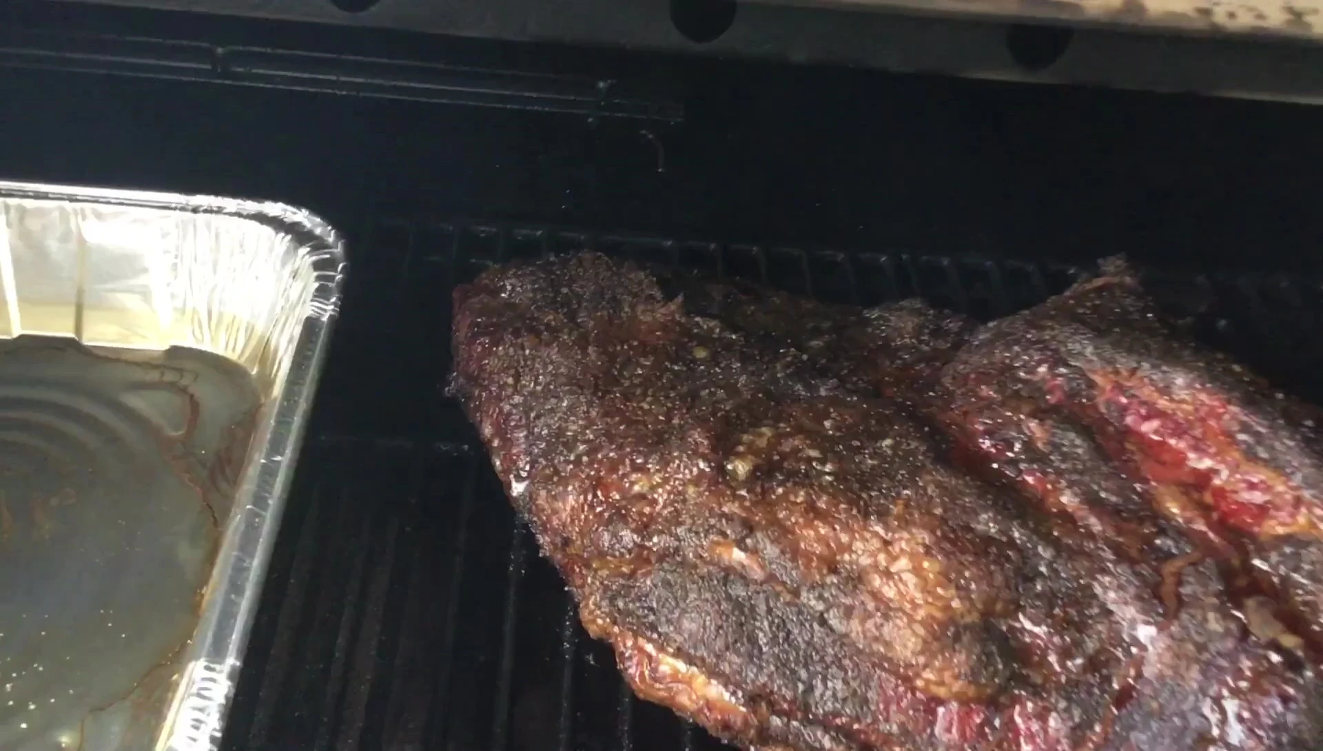Checking the temperature of the brisket on the pellet grill.