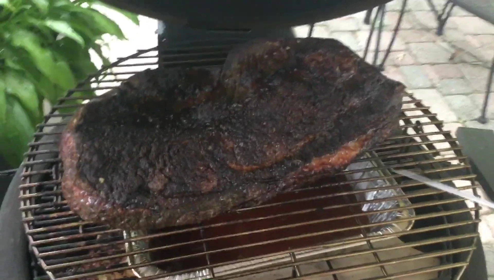 Checking the temperature of the brisket on the kamado grill.