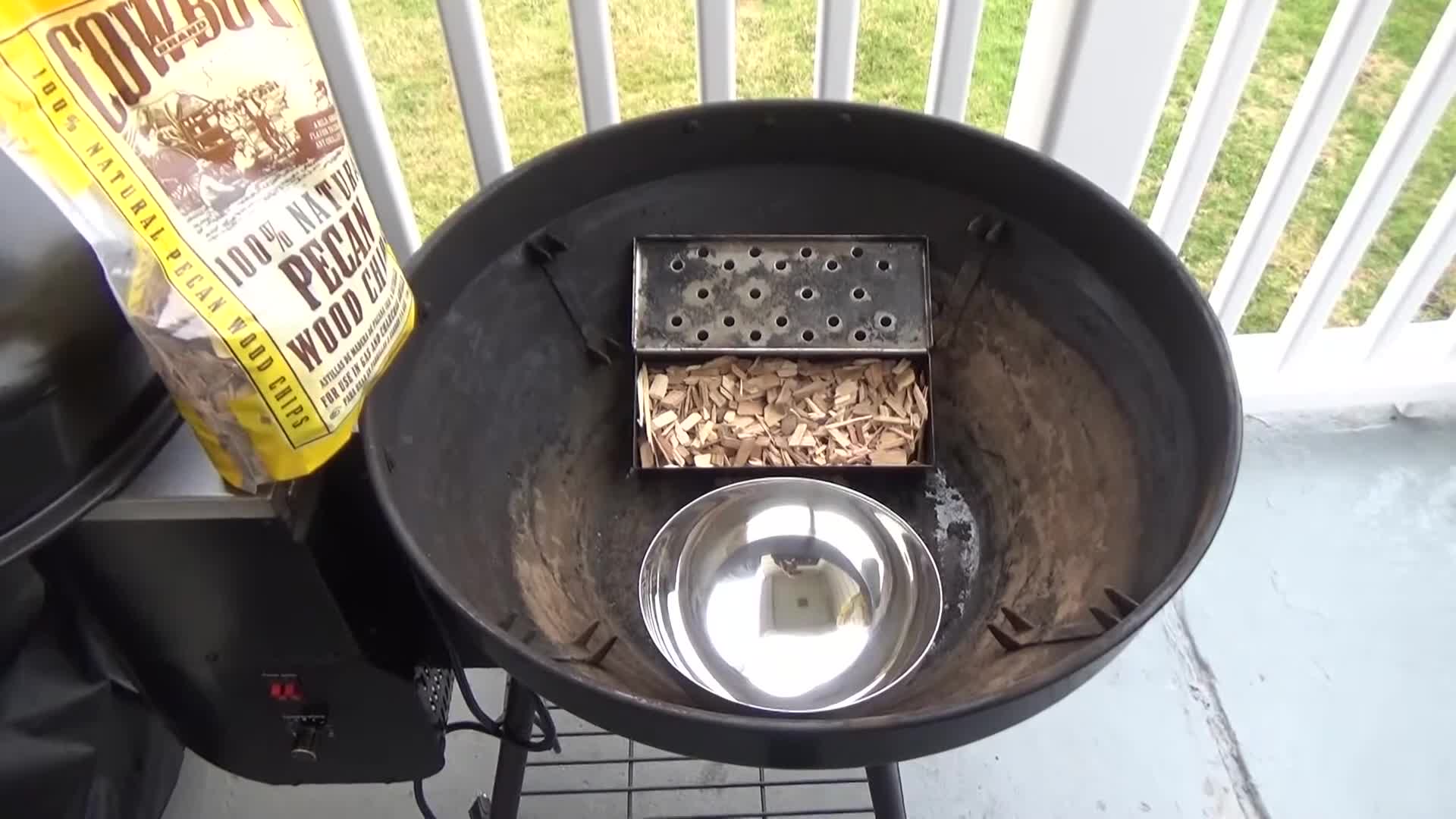 View of the smoke box filled with pecan wood chips.